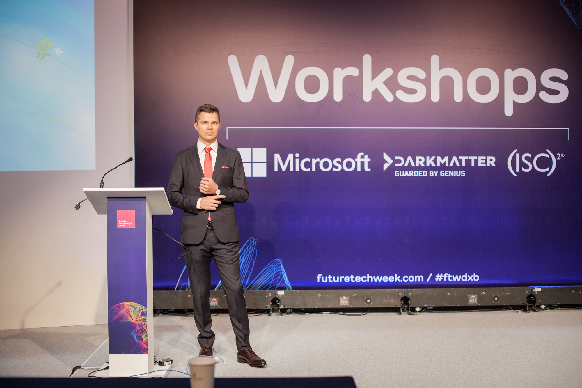 Alexander Sverdlov presenting on stage at Future Technology Week